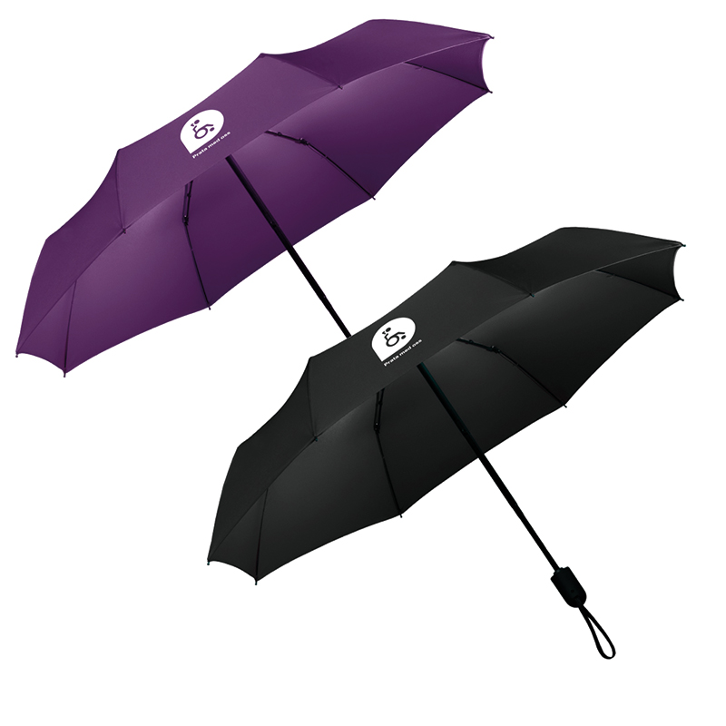 DHR:s paraply i ett svart och ett lila exemplar . Båda med vitt tryck av en pratbubbla innehållande bild av en stiliserad kvinna i rullstol.